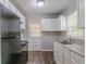Practical kitchen equipped with a double sink and plentiful white cabinets at 2239 Carey Se Dr, Atlanta, GA 30315