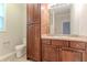 Bathroom features a single vanity and wooden cabinets and a tiled floor at 2378 Randall Ave, Lithonia, GA 30058