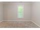 Bedroom with neutral walls, plush carpet, and bright window at 2378 Randall Ave, Lithonia, GA 30058