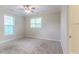 Light-filled bedroom featuring multiple windows and plush carpet at 2378 Randall Ave, Lithonia, GA 30058