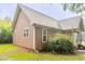 Side exterior view of house with a brown siding and white windows at 2378 Randall Ave, Lithonia, GA 30058