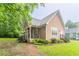 A charming one story home with light pink siding and stone accents, with lush foliage and a covered porch at 2378 Randall Ave, Lithonia, GA 30058