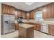 Beautiful kitchen with stainless steel appliances, granite countertops, island, and dark wood cabinetry at 2378 Randall Ave, Lithonia, GA 30058