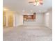 Open-concept living space featuring neutral carpet and paint, open to kitchen and dining area at 2378 Randall Ave, Lithonia, GA 30058