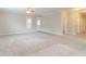 Spacious living room with neutral carpet and walls, featuring a ceiling fan and bright, natural light at 2378 Randall Ave, Lithonia, GA 30058