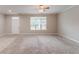 Expansive living room with carpet, neutral wall color, and white trim, filled with natural light at 2378 Randall Ave, Lithonia, GA 30058