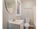 This bathroom offers a single sink vanity, window, and toilet at 2817 Burton Nw Rd, Atlanta, GA 30311