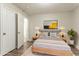 This staged bedroom features gray wood-look floors, soft lighting from side lamps and a plush shag rug at 2817 Burton Nw Rd, Atlanta, GA 30311