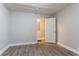 A bright bedroom features sleek, gray wood-look flooring and neutral paint, offering a modern, clean aesthetic at 2817 Burton Nw Rd, Atlanta, GA 30311