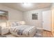 A staged bedroom features neutral color palette with wood floors, a cozy rug and a modern styled bed at 2817 Burton Nw Rd, Atlanta, GA 30311