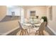 Bright dining room features a modern round glass table and light-colored floors at 2817 Burton Nw Rd, Atlanta, GA 30311