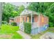 Attractive brick home with a welcoming front porch and manicured bushes at 2817 Burton Nw Rd, Atlanta, GA 30311