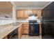 Modern kitchen featuring wood cabinets and black appliances at 2817 Burton Nw Rd, Atlanta, GA 30311