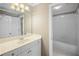 Bright bathroom with vanity, mirror, and white cabinetry next to an open bath and shower combination at 3725 Paces Park Se Cir, Smyrna, GA 30080