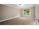 Bedroom with neutral walls, carpet, white trim, and a window overlooking the private backyard at 3725 Paces Park Se Cir, Smyrna, GA 30080