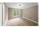 Bedroom with neutral carpet, window with wooded view, and ample natural light at 3725 Paces Park Se Cir, Smyrna, GA 30080