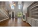 Bright living room with hardwood floors, large windows, fireplace, and staircase to the second floor at 3725 Paces Park Se Cir, Smyrna, GA 30080