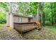 Backyard featuring a small wood deck and a view of the home with light siding at 5218 Tina Ct, Stone Mountain, GA 30083