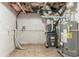 Utility area of an unfinished basement showcasing exposed ductwork, HVAC, and water heater at 5218 Tina Ct, Stone Mountain, GA 30083