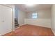 Finished basement area featuring tiled flooring, wainscotting, and a stairway to the upper level at 5218 Tina Ct, Stone Mountain, GA 30083