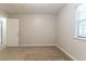 Simple and carpeted bedroom with a window and ample space for customization at 5218 Tina Ct, Stone Mountain, GA 30083