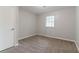 Clean, simple bedroom with carpet flooring, a window for natural light, and essential features at 5218 Tina Ct, Stone Mountain, GA 30083