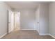 Neutral bedroom featuring plush carpet, fresh paint, and an open doorway to additional living space at 5218 Tina Ct, Stone Mountain, GA 30083