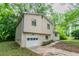 Split-level home with beige siding, a single-car garage, and small front yard at 5218 Tina Ct, Stone Mountain, GA 30083