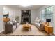 Living room features neutral furniture, stone fireplace, and large window at 5218 Tina Ct, Stone Mountain, GA 30083