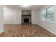 Living room features fireplace, wood floors, and a bright window at 5218 Tina Ct, Stone Mountain, GA 30083