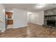 Open-concept space with fireplace, wood floors, and entry to kitchen at 5218 Tina Ct, Stone Mountain, GA 30083