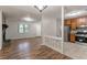 Living space featuring stone fireplace, wood floors, and modern kitchen at 5218 Tina Ct, Stone Mountain, GA 30083