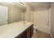 This bathroom has a sink, vanity, toilet, shower, and large mirror at 545 Offaly Ln, Atlanta, GA 30349