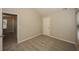 This bedroom has neutral walls and carpet and also has a window for plenty of natural light at 545 Offaly Ln, Atlanta, GA 30349