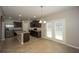 Bright kitchen with island, stainless steel appliances, and easy access to the backyard through glass doors at 545 Offaly Ln, Atlanta, GA 30349