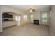 Open-concept living room features a fireplace and seamless flow into the kitchen and dining area at 545 Offaly Ln, Atlanta, GA 30349