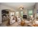 Staged living room with a fireplace and open layout leading to the kitchen and dining area at 545 Offaly Ln, Atlanta, GA 30349