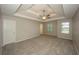 Spacious main bedroom featuring tray ceilings, plush carpeting, and ample natural light at 545 Offaly Ln, Atlanta, GA 30349