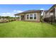 Well-manicured backyard with lush green lawn, a covered porch, and privacy fencing, creating a serene outdoor space at 2012 Ripple Park Bend, Canton, GA 30114