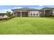 Expansive backyard featuring lush green grass, a covered porch, and ample space for outdoor activities and relaxation at 2012 Ripple Park Bend, Canton, GA 30114