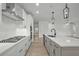 Open kitchen featuring a gas range, stainless hood, and island with bar seating at 2012 Ripple Park Bend, Canton, GA 30114