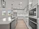 Modern kitchen with stainless steel appliances, white cabinets, and an island with sink at 2012 Ripple Park Bend, Canton, GA 30114