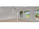 Bright living room featuring an accent wall, large windows, and a glass door to the backyard at 2012 Ripple Park Bend, Canton, GA 30114