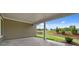 Covered patio with a view of the landscaped backyard and a clear blue sky at 2012 Ripple Park Bend, Canton, GA 30114