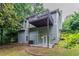 View of the two-story home highlighting the backyard with a deck and patio at 2654 Laurel View Dr, Snellville, GA 30039