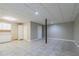 Open basement area with neutral walls, tile flooring and kitchenette at 2654 Laurel View Dr, Snellville, GA 30039