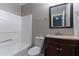 Well-lit bathroom featuring a vanity with granite countertop, toilet, shower/tub with tile surround and updated fixtures at 2654 Laurel View Dr, Snellville, GA 30039