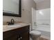 Well-maintained bathroom featuring a vanity with granite countertop, toilet, shower/tub with updated fixtures at 2654 Laurel View Dr, Snellville, GA 30039
