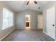 Bright bedroom with vaulted ceilings, neutral walls, plush carpeting, window, and doorway to the en-suite bathroom at 2654 Laurel View Dr, Snellville, GA 30039