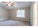 Cozy bedroom featuring neutral walls, plush carpeting, a ceiling fan, and a window offering natural light at 2654 Laurel View Dr, Snellville, GA 30039